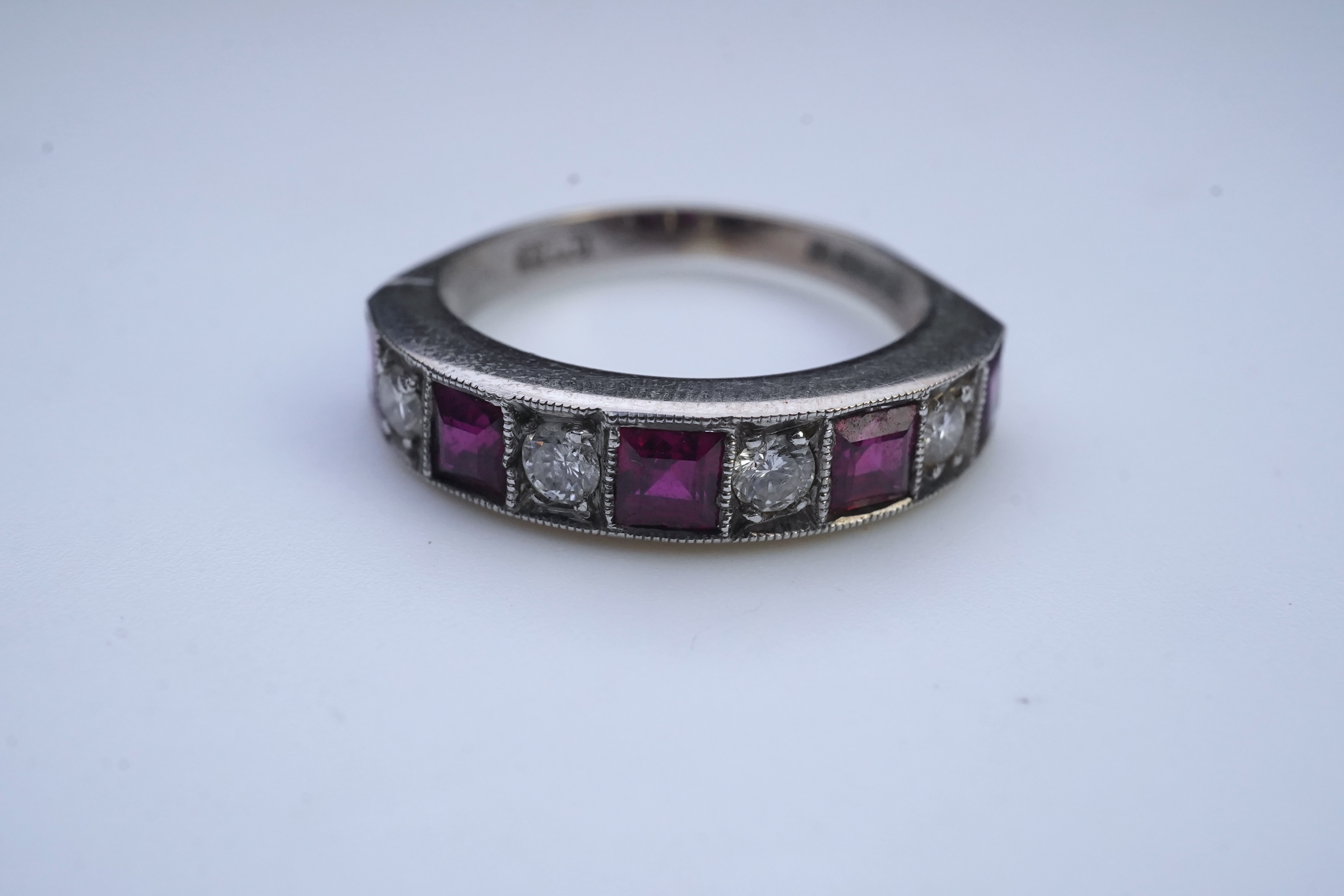 A ruby and diamond half eternity ring